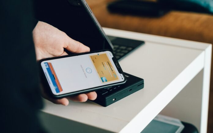 Person using a smartphone to send money, representing diaspora remittances sent home to Nigeria