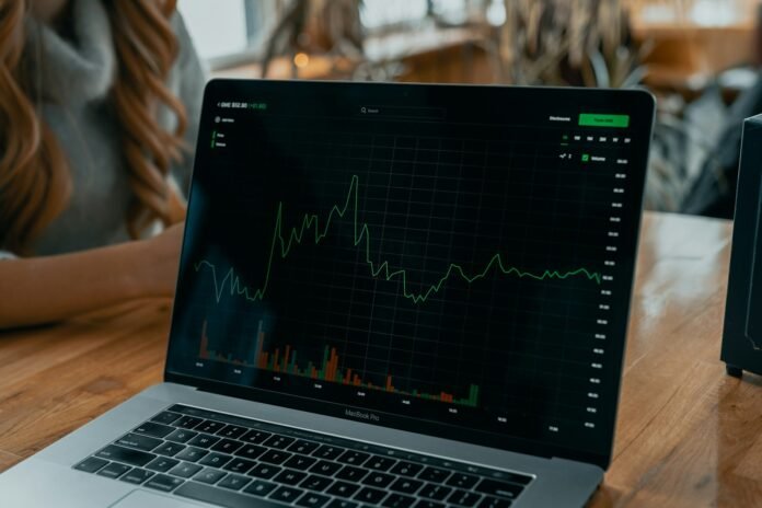 Laptop showing an investment chart, representing investing decisions during inflation in Nigeria