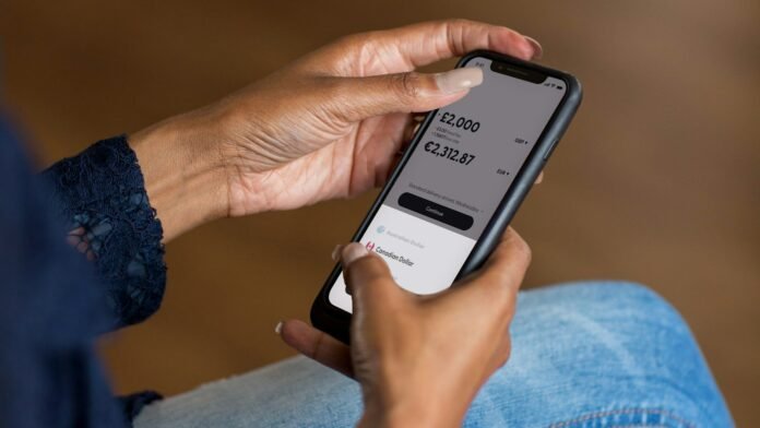Person holding a smartphone, representing mobile digital banking apps in Nigeria