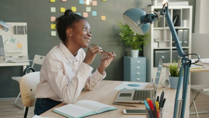 Young professional at her desk, representing how inflation affects salary purchasing power in Nigeria