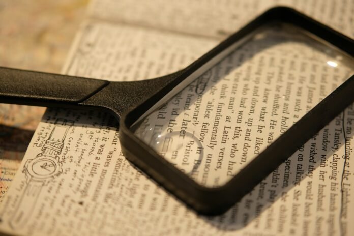 Magnifying glass over text, representing decoding Nigeria's key inflation numbers